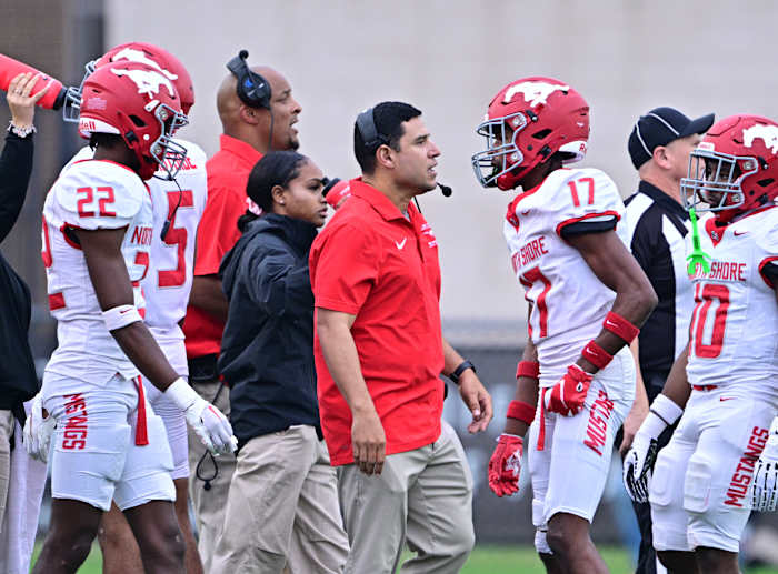 North Shore players, coaches meet on the sideline during a 6A Division I state semifinal win over Westlake on December 9.